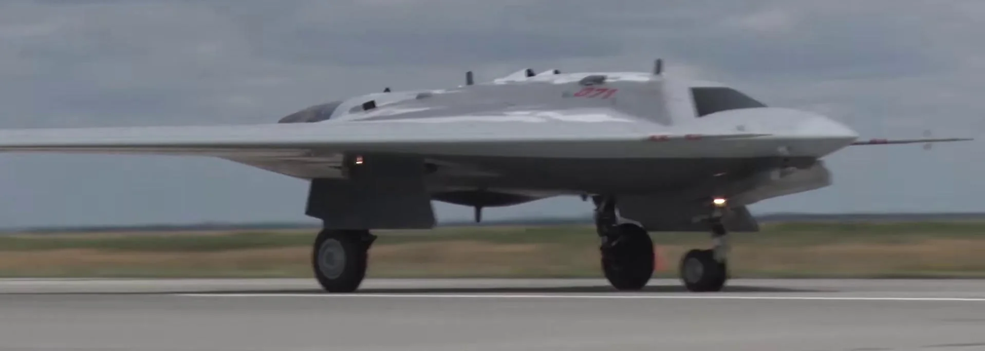 Front view of Sukhoi S-70 Okhotnik during takeoff.